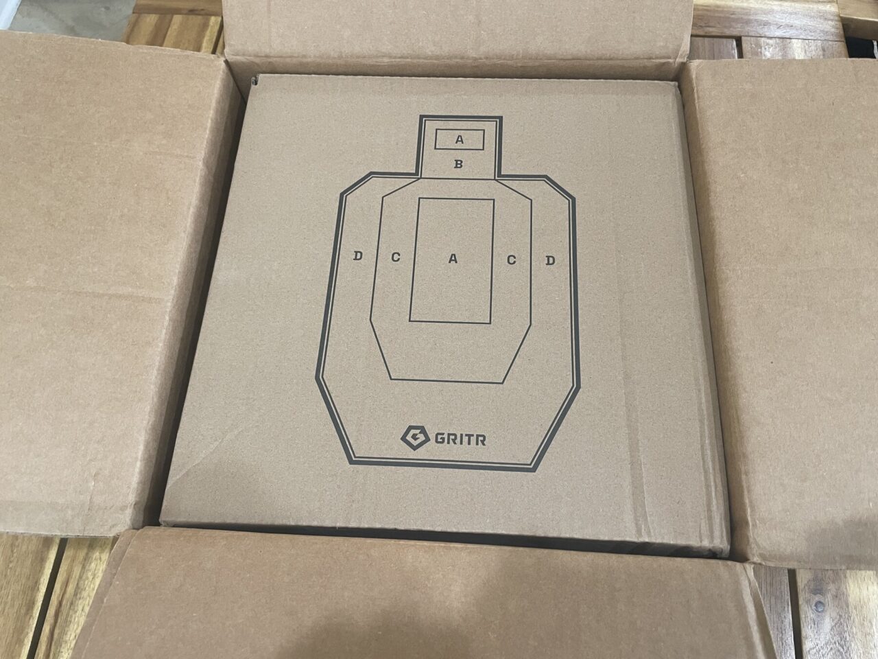 Open GRITR Pistol Pod shipping box with fitted cardboard inner packaging