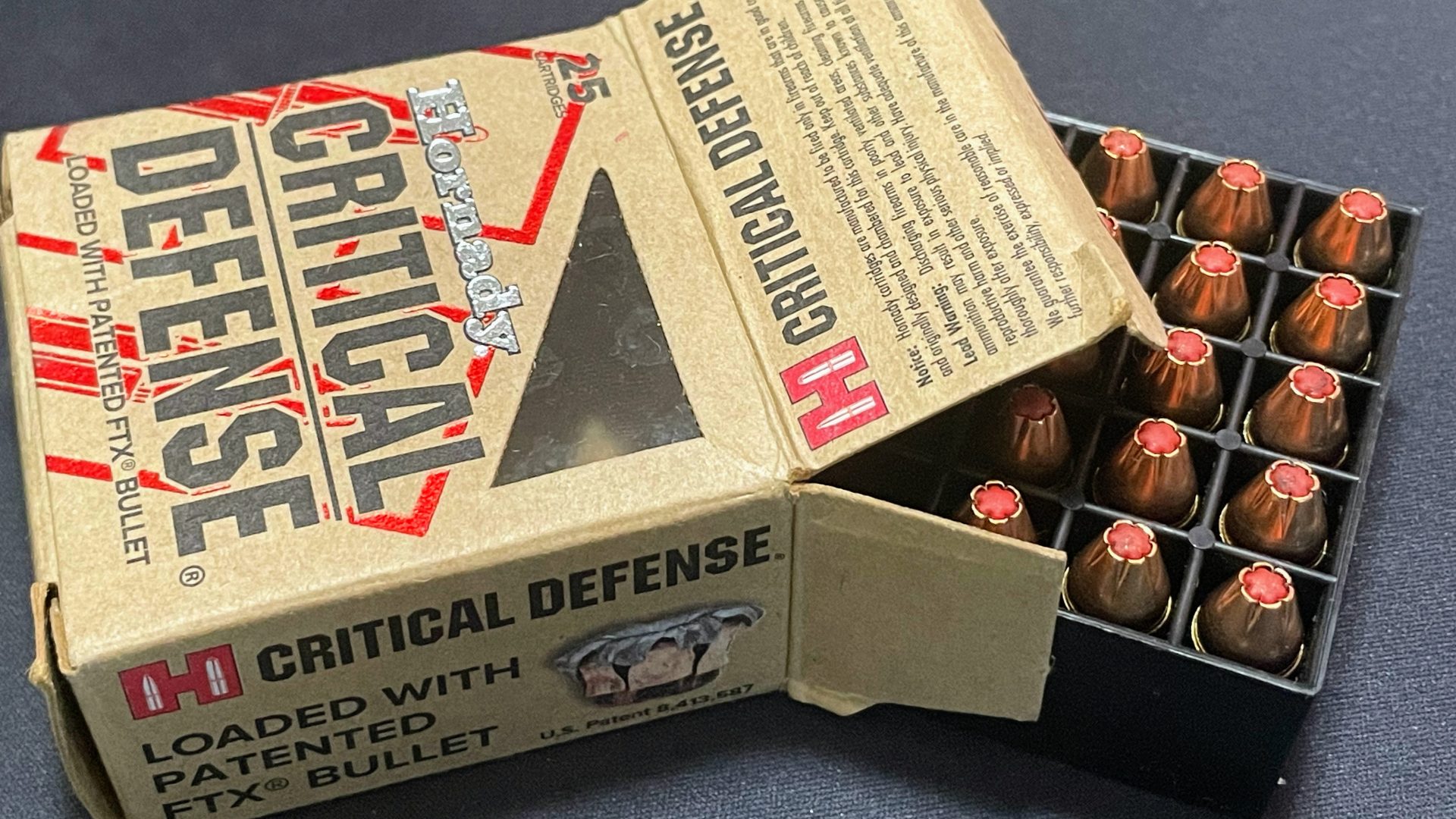 opened Hornady Critical Defense 9mm ammo box with rounds coming out side
