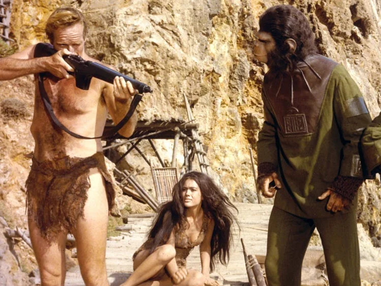 Charlton Heston as Taylor aiming the modified M1 Carbine ape rifle in Planet of the Apes