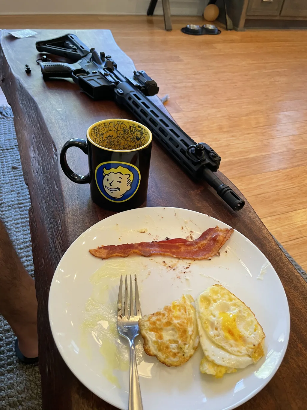 fallout coffee cup, bacon, eggs, and an ar15 rifle