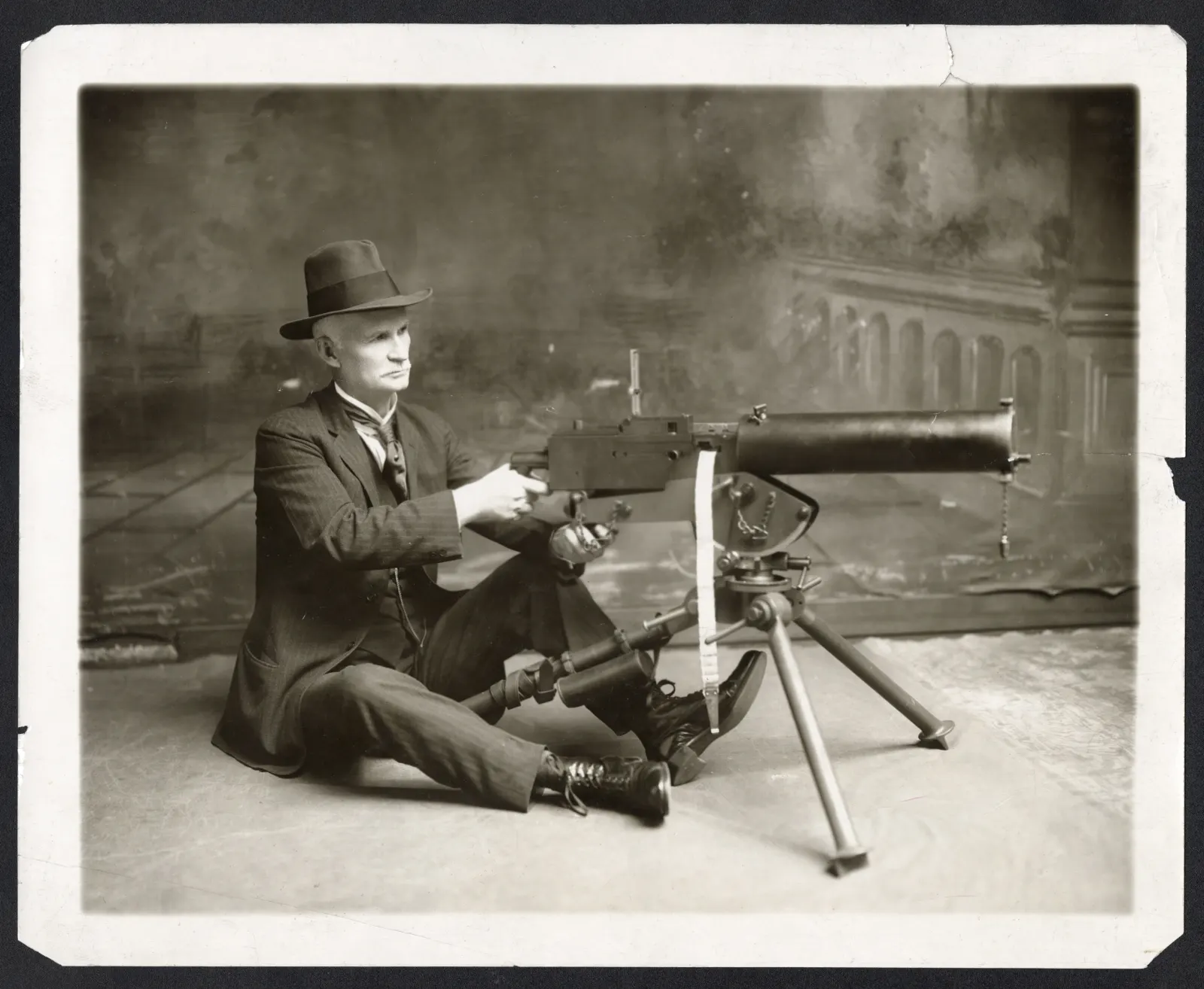John Moses Browning seated with a firearm